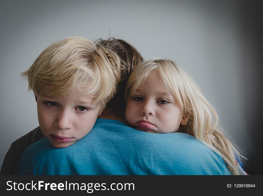 Sad Little Boy And Girl Hugging Father, Family In Sorrow