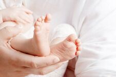 Baby Feet In Mother Hands. Tiny Newborn Baby`s Feet On Female Ha Stock Images