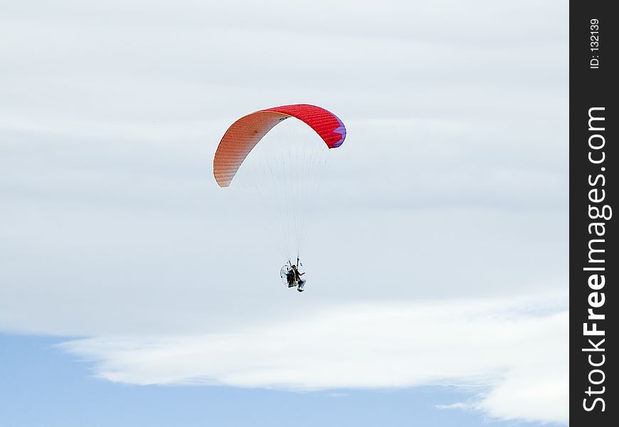 Red Hang glider in the clouds