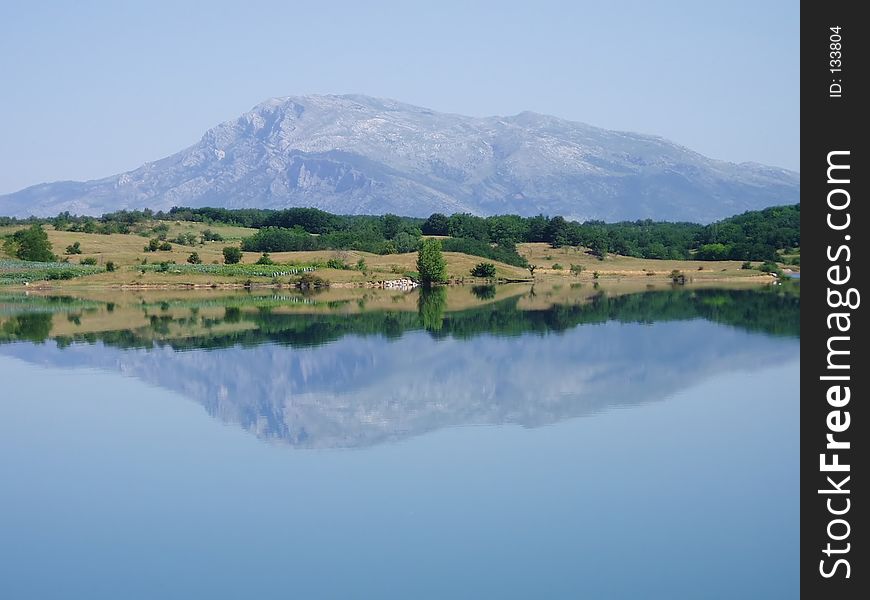 Mountain reflecting in perfectly calm lake. Mountain reflecting in perfectly calm lake