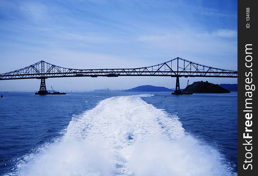 Long shot of Richmond San Rafael bridge North of San Francisco, in between San Rafael and Richmond.Taken from the deck of a ferry boat, water trail apparent. Long shot of Richmond San Rafael bridge North of San Francisco, in between San Rafael and Richmond.Taken from the deck of a ferry boat, water trail apparent.