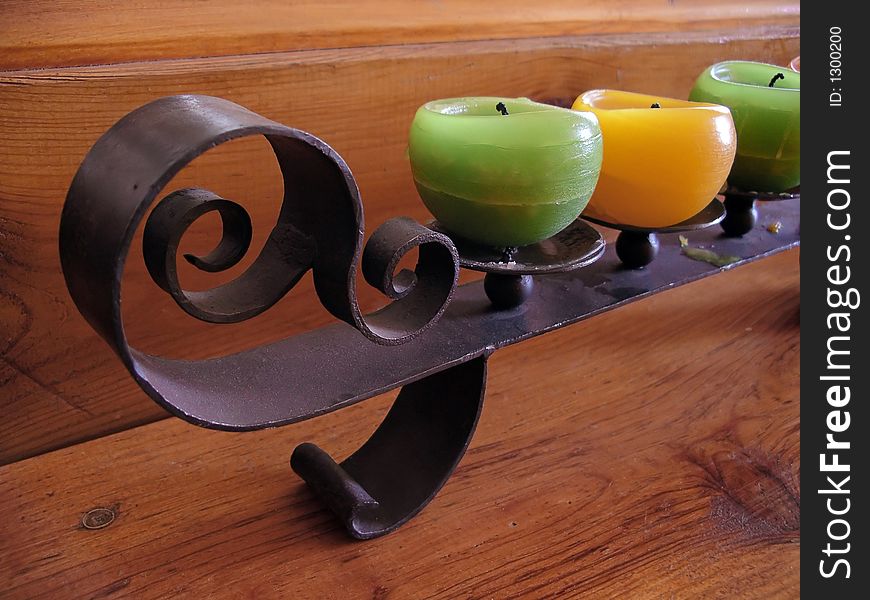 Three wax candles and decorative iron holder. Three wax candles and decorative iron holder.