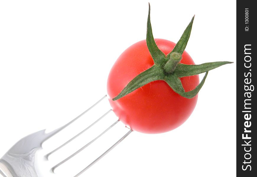 Tomatoes against a white background on a fork