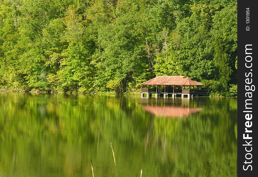 Landscape of lake with boathouse.