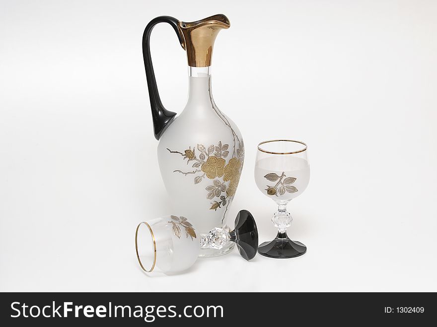 A jug and two glasses on a white background