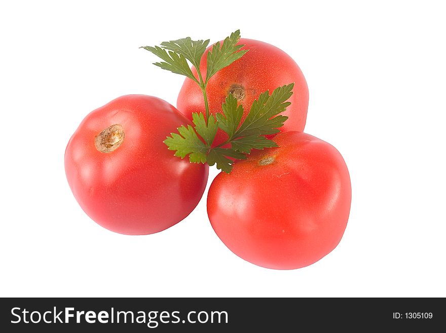 Three isolated tomatoes and parsley