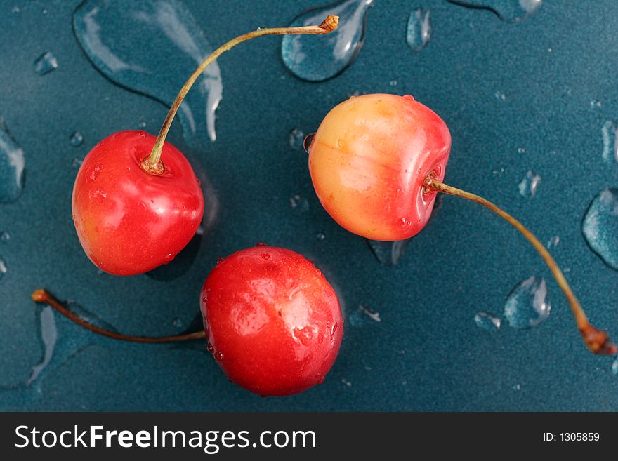 Cherries with drips on metal surface