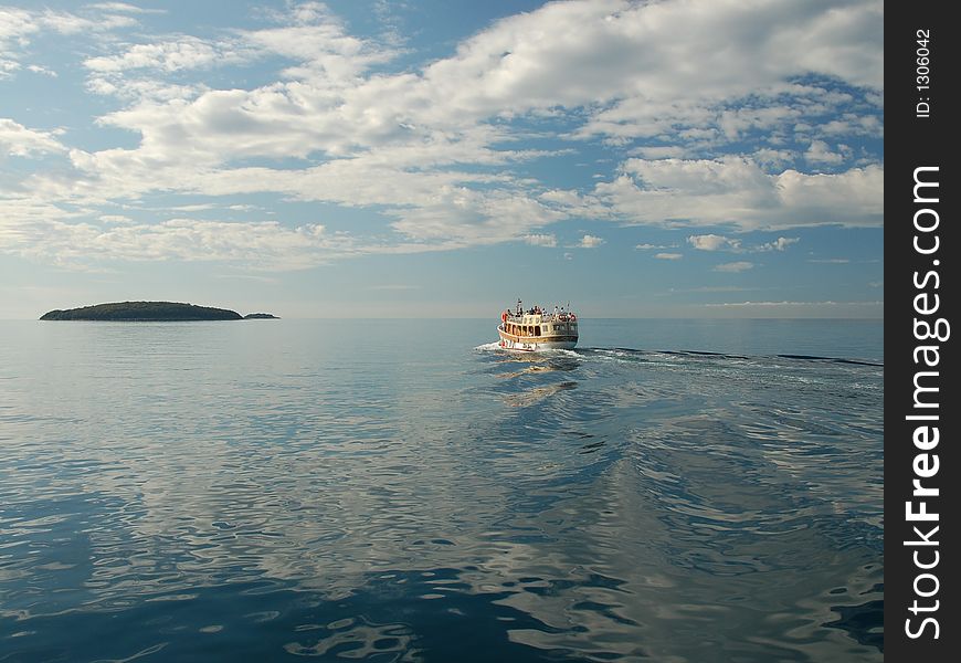 Deep blue sea with island and boat. Deep blue sea with island and boat