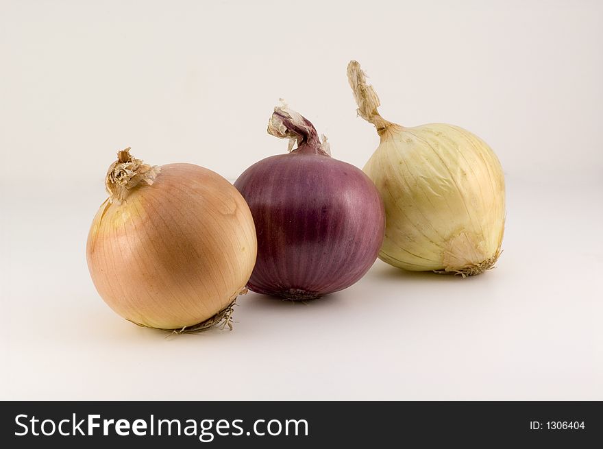 Three onions on a white background
