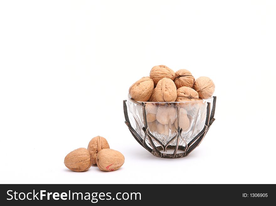 Glass bowl with many walnuts