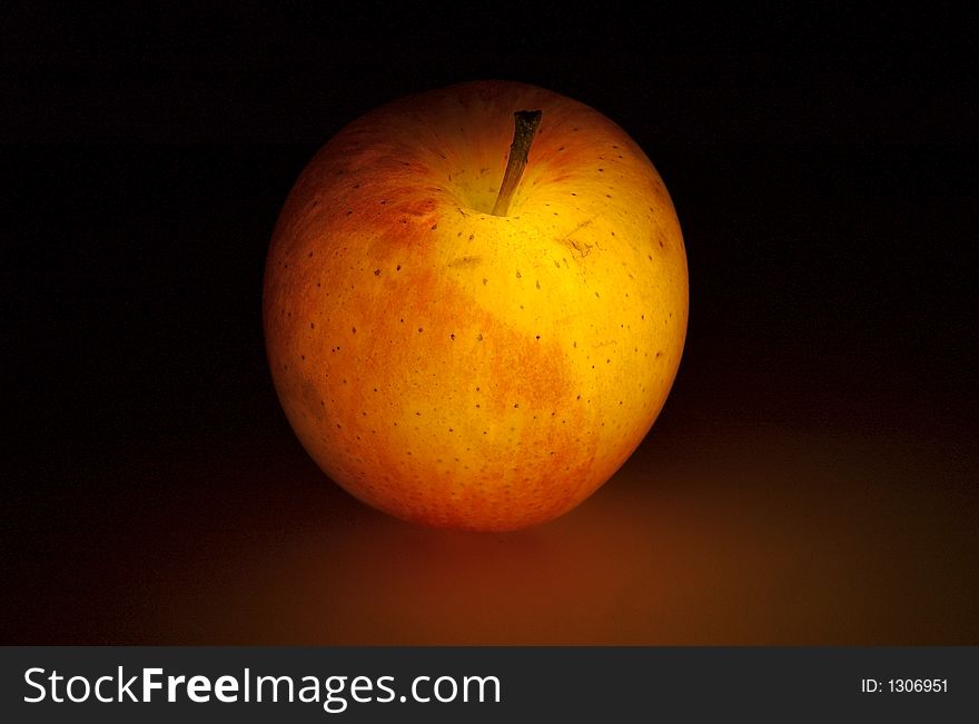 Glowing apple on dark background