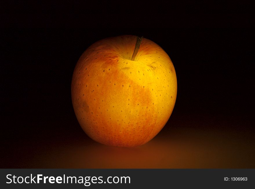 Glowing apple on dark background