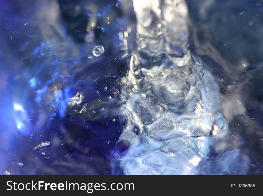 Close-up or Macro of pouring water into a blue bowl.