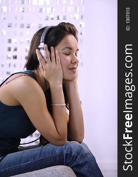 Beautiful young woman listening to music. Beautiful young woman listening to music
