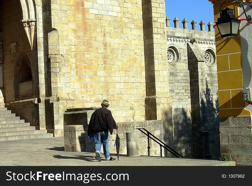 Old man passing together to the church of the Sé, Évora, Portugal. Old man passing together to the church of the Sé, Évora, Portugal