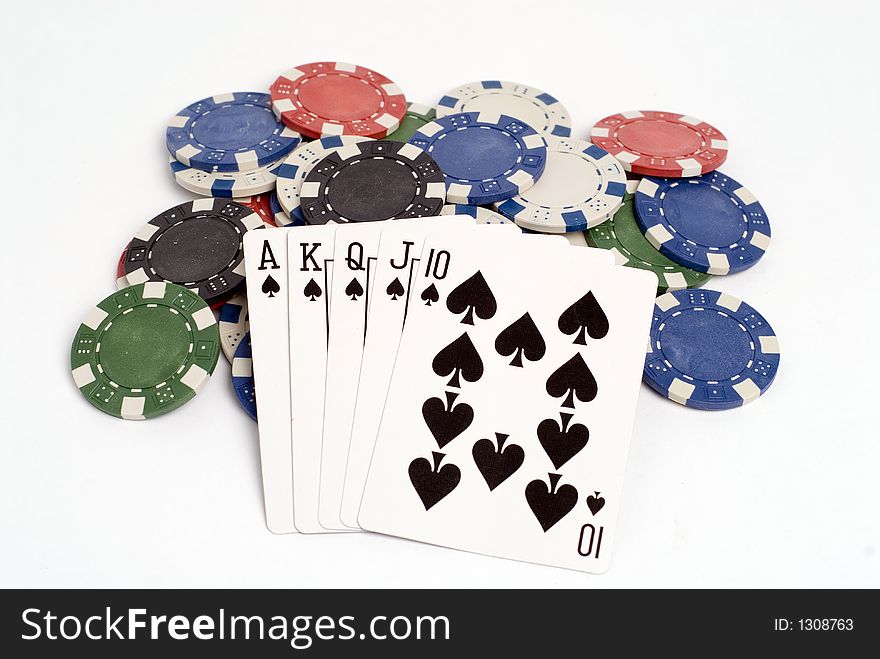 A royal straight flush hand with chips. A royal straight flush hand with chips.