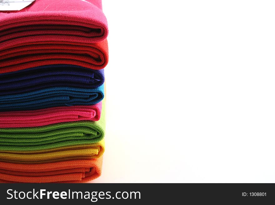 Bundle of coloured material on a white background