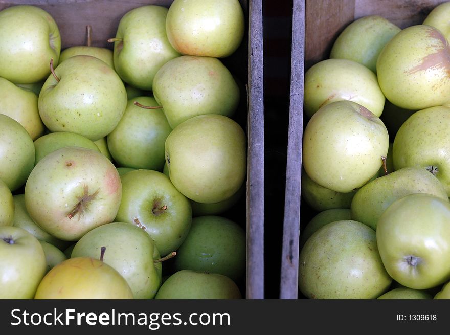 Wooden crates filled with freshly picked green apples. Wooden crates filled with freshly picked green apples.