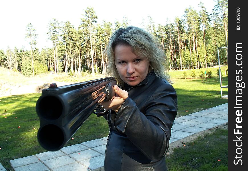 Young woman with double-barelled gun. Young woman with double-barelled gun