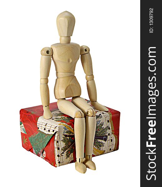 Mannequin sitting on a Christmas gift. Mannequin sitting on a Christmas gift