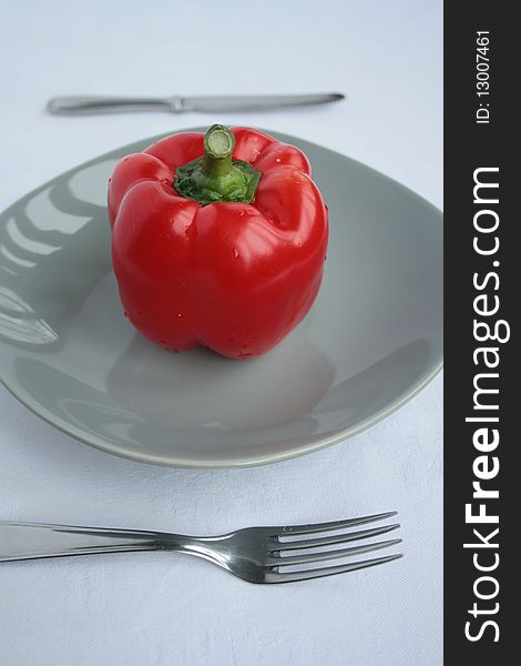 Healthy food concept red pepper on plate.