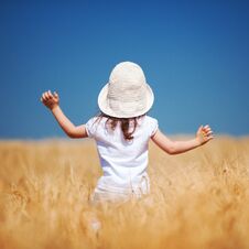 Happy Girl Walking In Golden Wheat, Enjoying The Life Stock Image