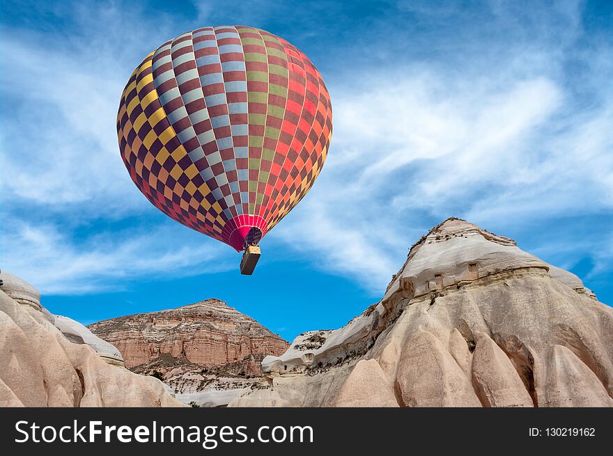 Hot Air Balloons Over Mountain Landscape In Cappadocia