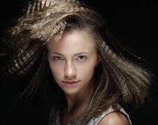 Portrait Of Young Blond Woman With Curly Hair Over Black Background Royalty Free Stock Image