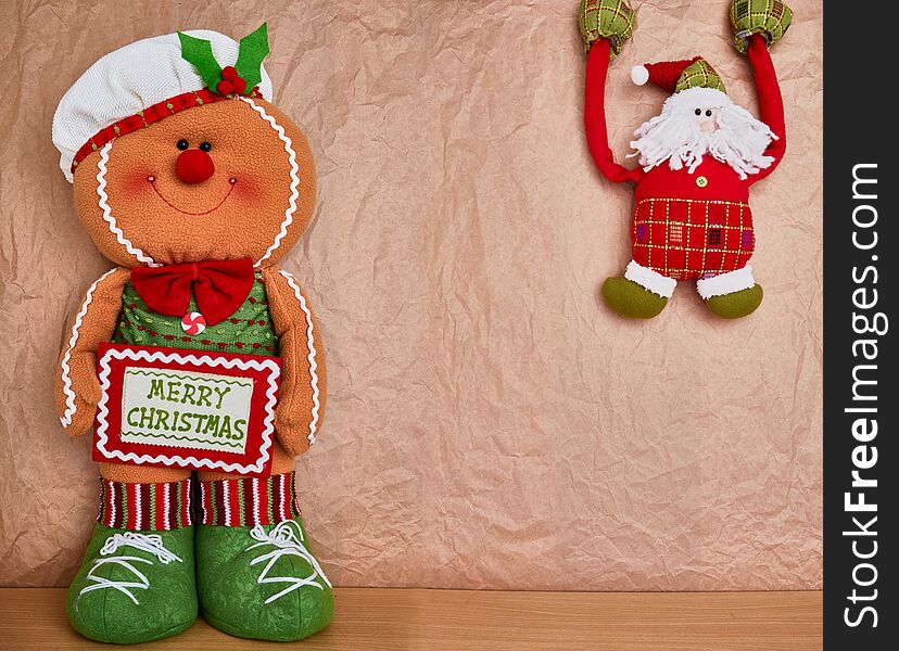 Christmas decoration over a kraft paper background, gingerbread and santa, text space