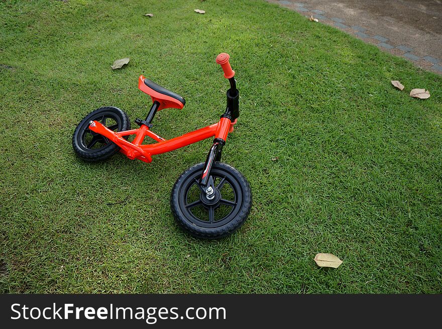 Kids balance bike on a grass background