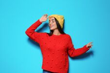 Young Woman In Warm Sweater And Hat On Color Background Stock Image Young Woman In Warm Sweater And Hat On Color Background Stock Image