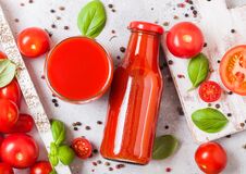 Bottle Of Fresh Organic Tomato Juice With Fresh Raw Tomatoes Basil And Pepper In Box On Stone Kitchen Background Stock Images