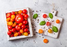 Organic Tomatoes With Basil In Vintage Wooden Box On Stone Kitchen Table Background. San Marzano, Orange And Plum Tomatoes Stock Image