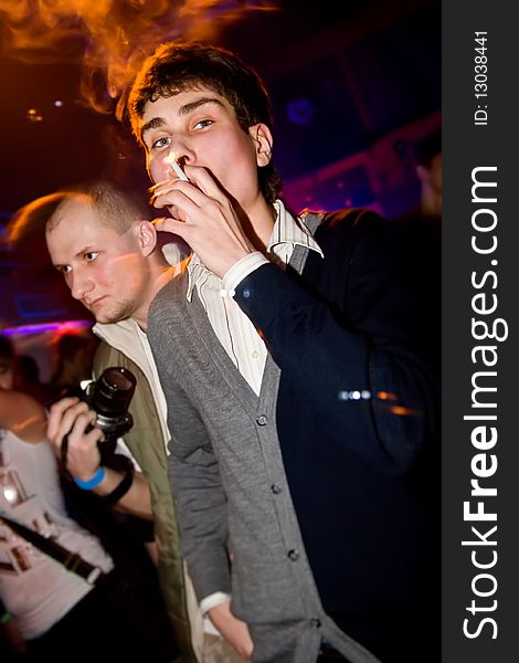 Young Man Smoking In The Nightclub