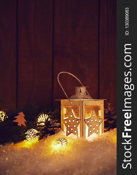 Christmas lantern with shining baubles and pine cones