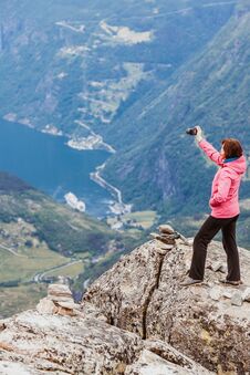 Tourist Taking Photo From Dalsnibba Viewpoint Norway Stock Photo