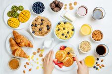 Breakfast Table Setting With Flakes, Juice, Croissants, Pancakes Royalty Free Stock Photos