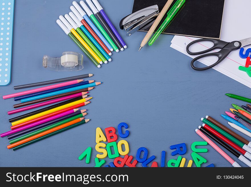 Back to school concept on a blue wooden background