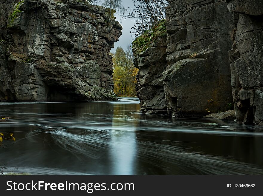 The River Is Fast With Stony Shores And Autumnal Yellow Trees. Autumn View Of The River.