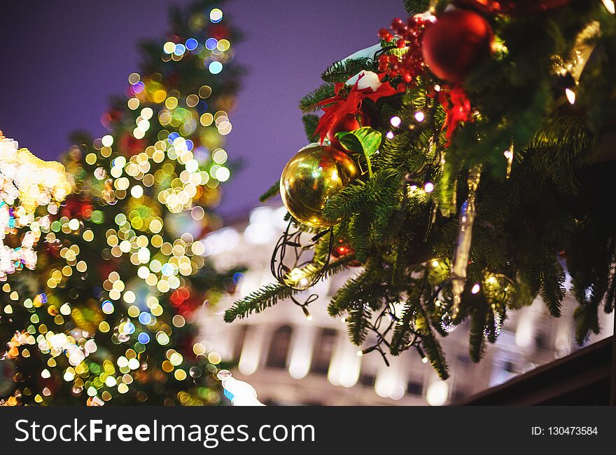 Beautiful New Year`s decor and Christmas-tree decorations on festive firs. Holiday, Christmas and New Year. Concept greeting card. Soft focus and beautiful bokeh.