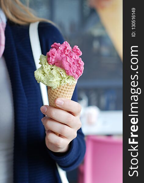 Hand Holding Colourful Ice-cream In A Cone Closeup