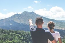 Young Couple Standing On A Mountain Background. Volcano Batur, Bali Island. Royalty Free Stock Photos Young Couple Standing On A Mountain Background. Volcano Batur, Bali Island. Royalty Free Stock Photos