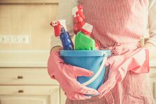 Cleaning Concept - Female Holding Cleaning Supplies In Blue Basket Royalty Free Stock Photography