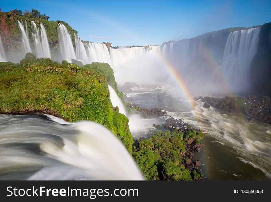 National Park of Iguazu Falls with a full rainbow over the water, Foz do Iguazu, Brazil. National Park of Iguazu Falls with a full rainbow over the water, Foz do Iguazu, Brazil