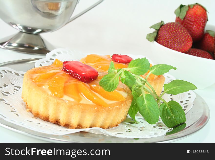 Apricot tart with lemon balm on a silver platter