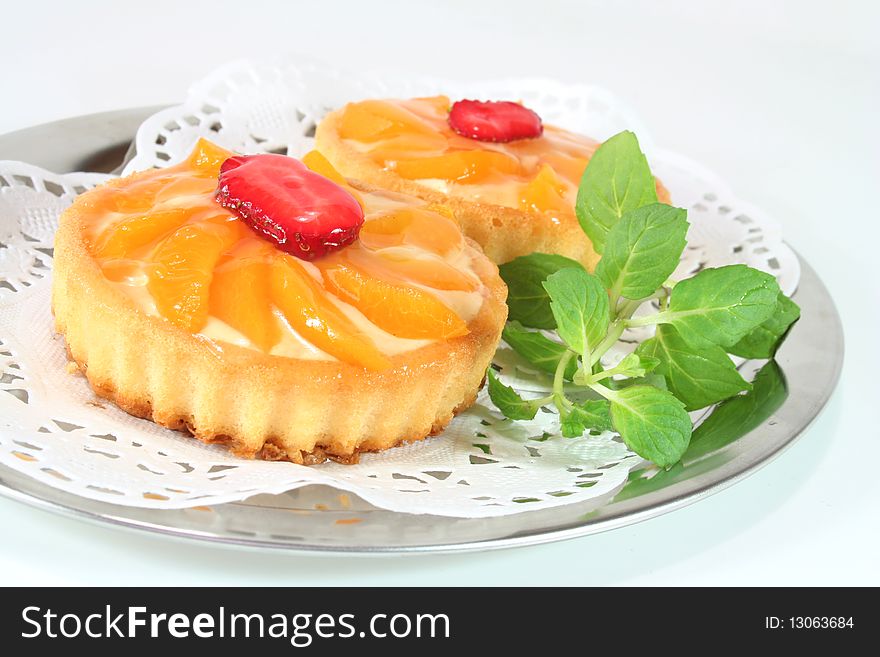 Apricot tart with lemon balm on a silver platter