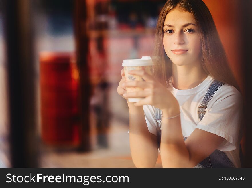 Young attractive pretty girl at cafe with coffee relax at mornin