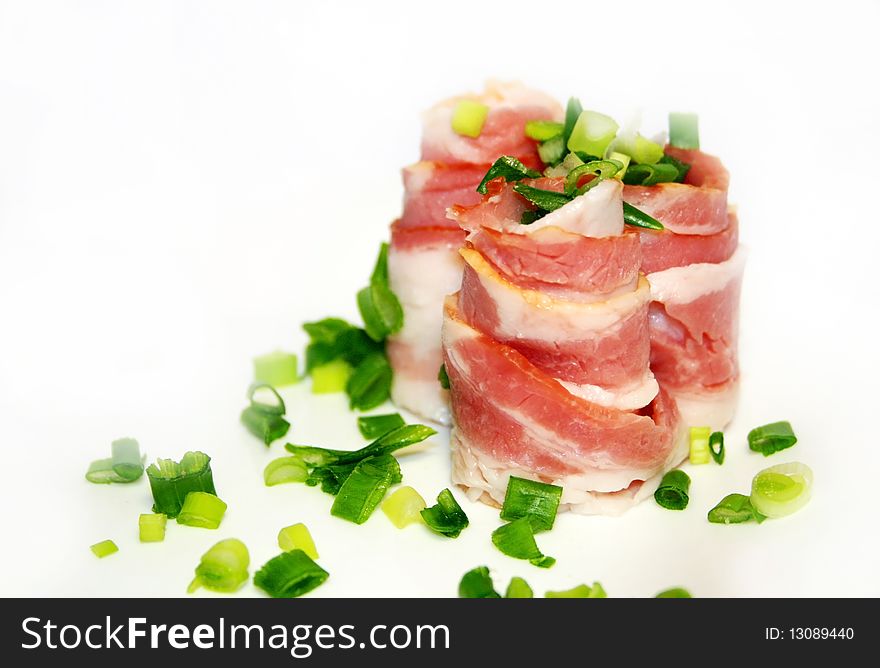 Bacon with green onion on a white background