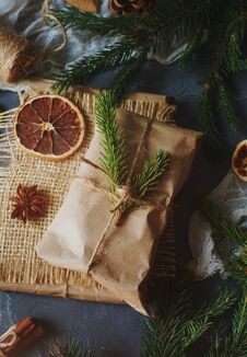 Christmas Or New Year Composition With Handmade Gifts, Dry Oranges, Cinnamon, Fir Tree On Dark Stone Table. Holidays Preparations, Stock Image