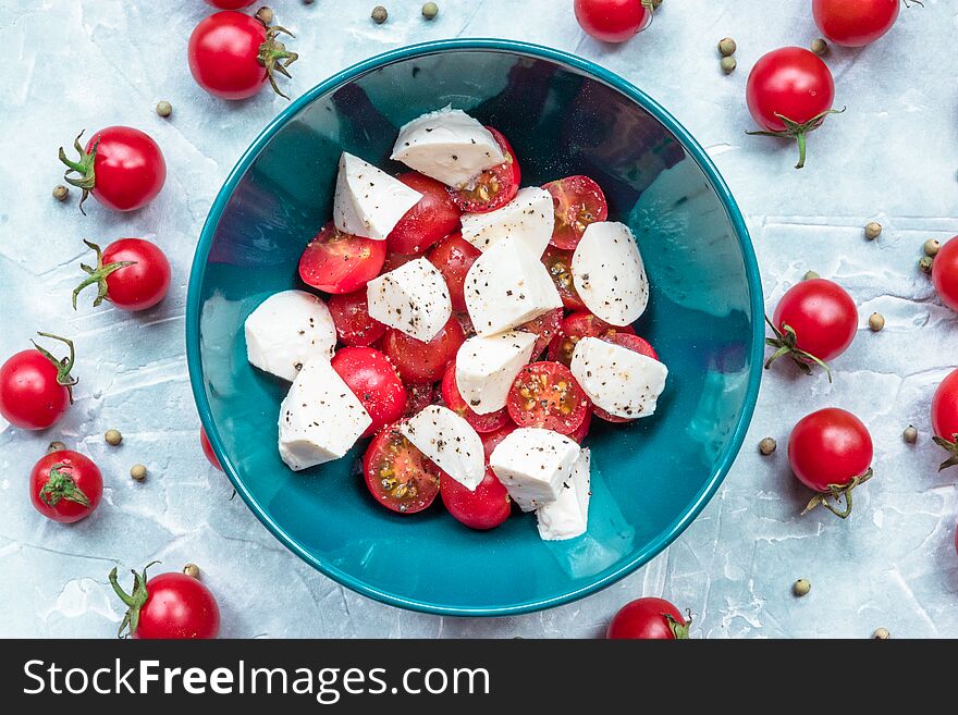 Italian food ingredients - mozzarella, tomatoes on concrete. view from above